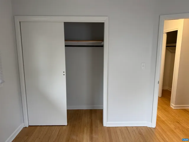 a view of walk in closet with wooden floor