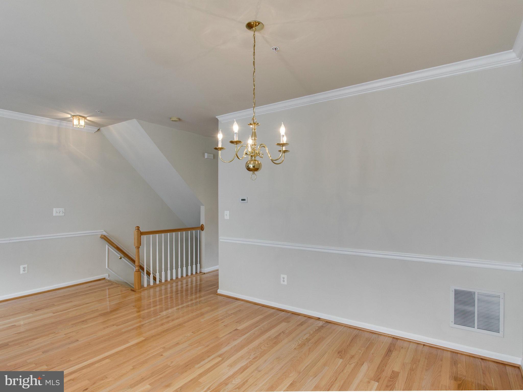 9823 Darcy Forest Drive Silver Spring, MD 20910 - Photo 12 of 30 a view of a room with wooden floor and ceiling fan