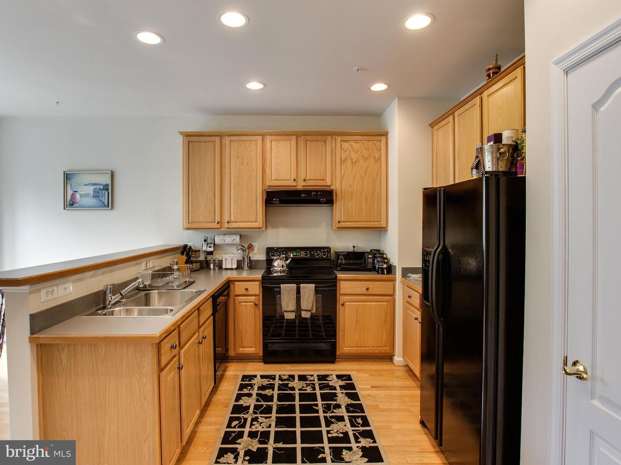 9823 Darcy Forest Drive Silver Spring, MD 20910 - Photo 16 of 30 a kitchen with stainless steel appliances granite countertop a stove a sink and a refrigerator