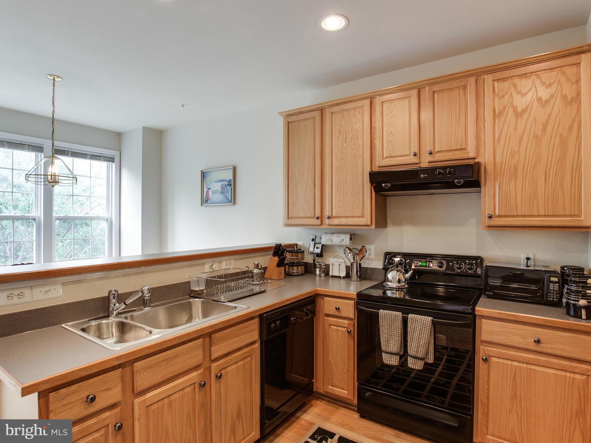 9823 Darcy Forest Drive Silver Spring, MD 20910 - Photo 18 of 30 a kitchen with a sink stove and cabinets