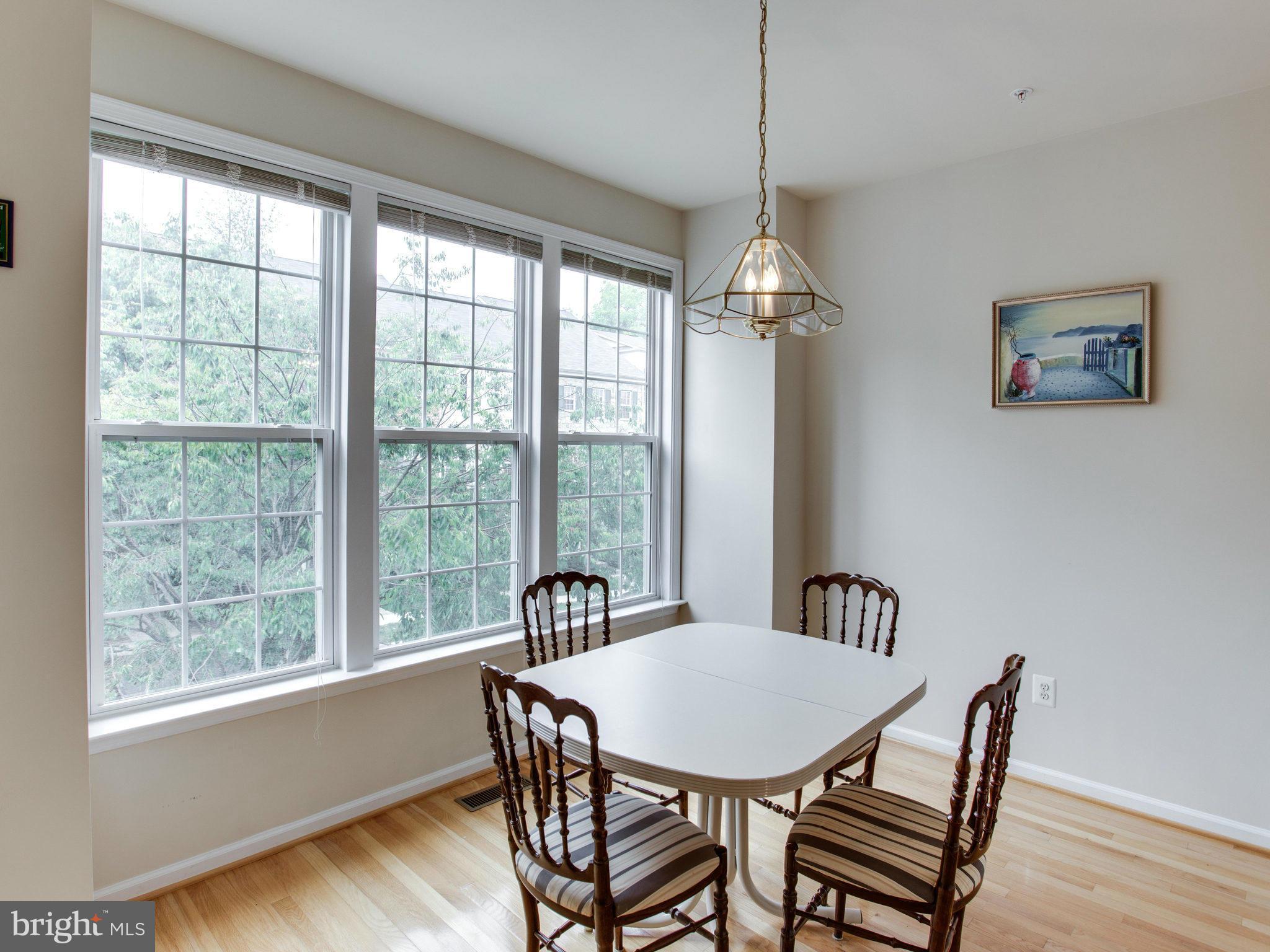 9823 Darcy Forest Drive Silver Spring, MD 20910 - Photo 20 of 30 a view of a dining room with furniture window and wooden floor