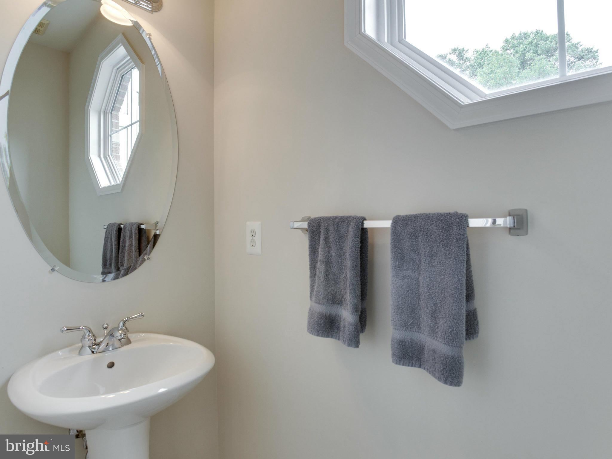 9823 Darcy Forest Drive Silver Spring, MD 20910 - Photo 22 of 30 a bathroom with a sink and a mirror