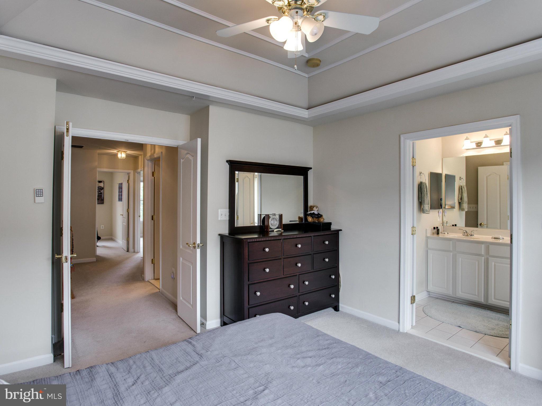 9823 Darcy Forest Drive Silver Spring, MD 20910 - Photo 25 of 30 a view of a room with a mirror and a ceiling fan