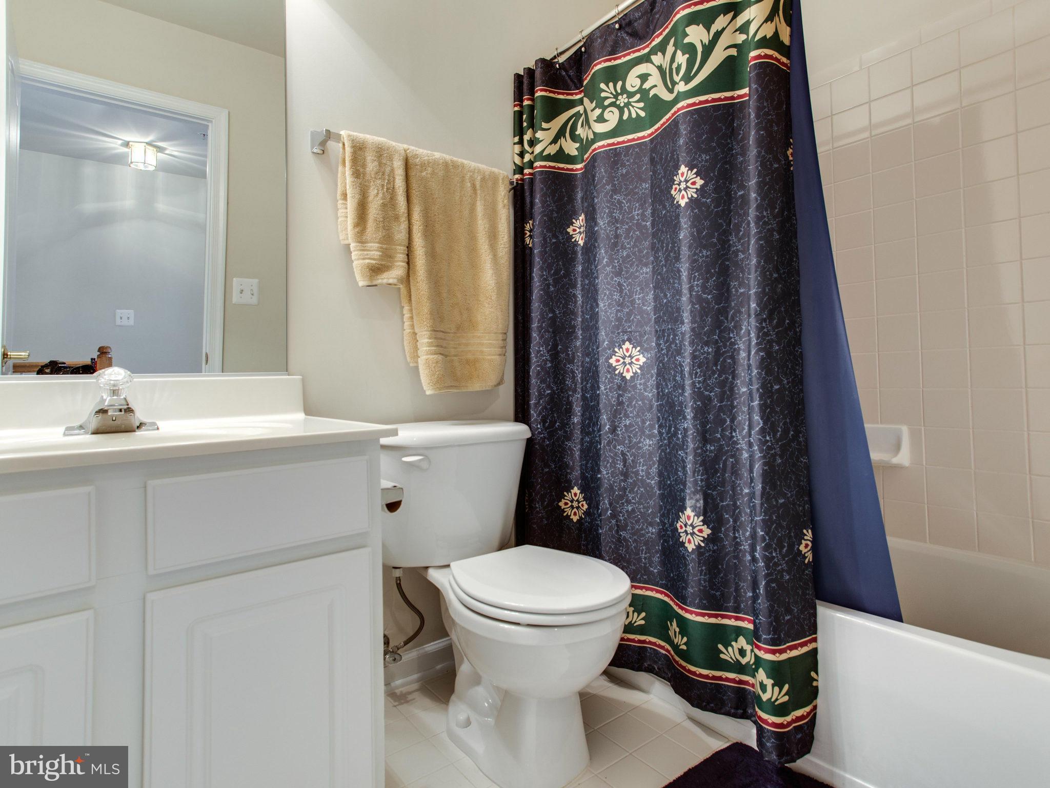 9823 Darcy Forest Drive Silver Spring, MD 20910 - Photo 28 of 30 a bathroom with a sink toilet and shower