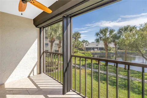 a view of swimming pool with outdoor seating and house in the background