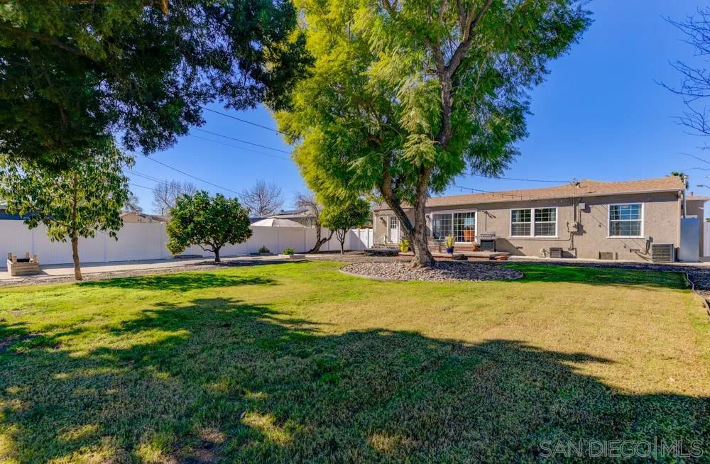 6244 Lorca Drive San Diego, CA 92115 - Photo 15 of 25 a view of a house with swimming pool and a yard