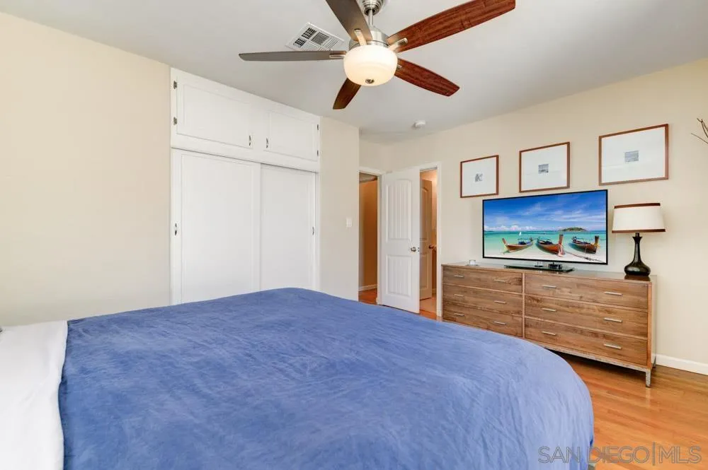 6244 Lorca Drive San Diego, CA 92115 - Photo 19 of 25 a view of a bedroom with cabinet and a ceiling fan