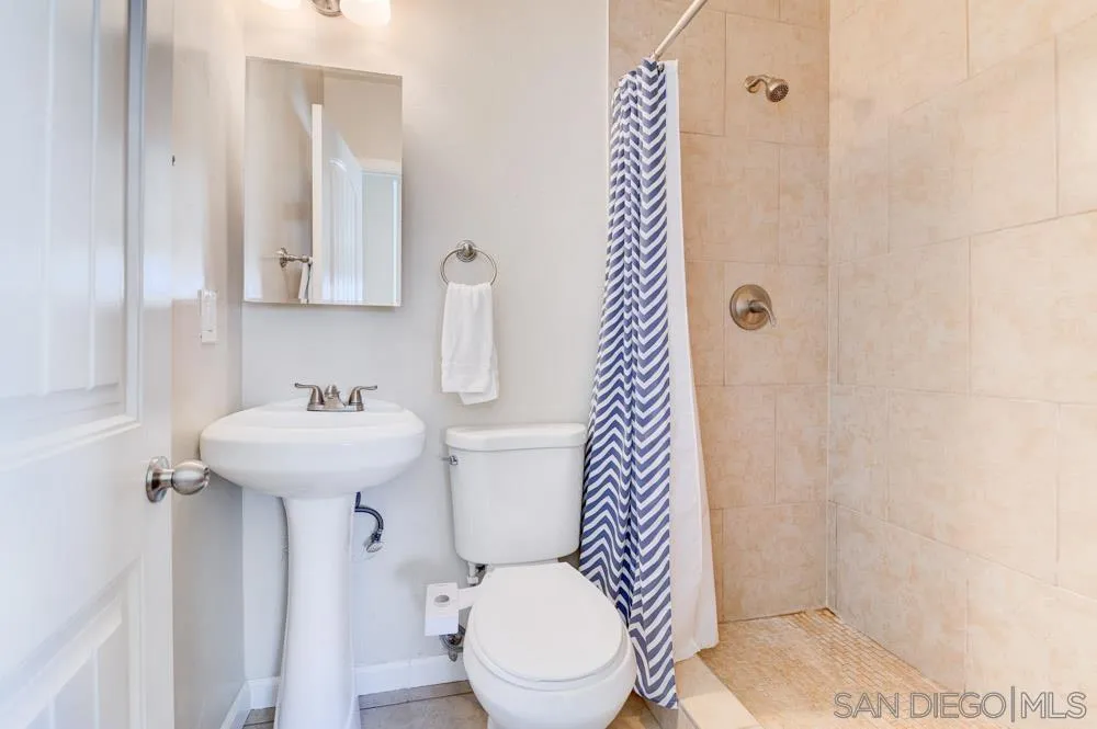 6244 Lorca Drive San Diego, CA 92115 - Photo 20 of 25 a bathroom with a sink toilet and shower
