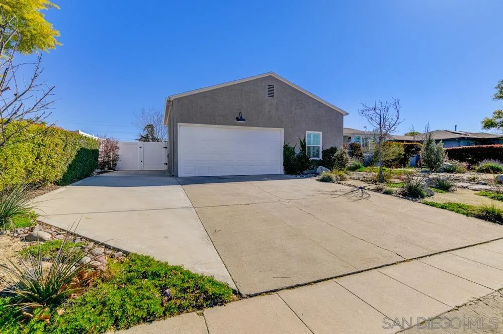 6244 Lorca Drive San Diego, CA 92115 - Photo 25 of 25 a front view of a house with a yard and garage