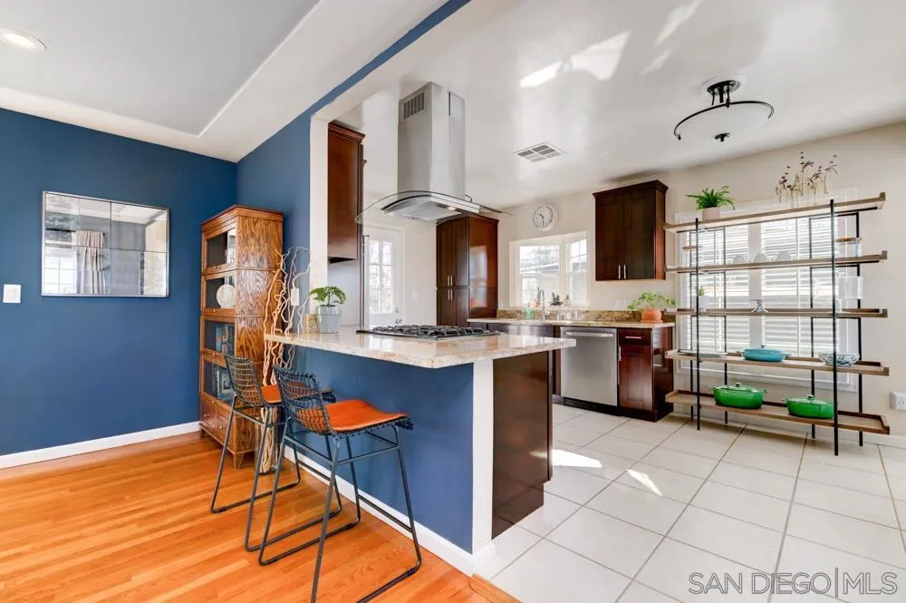 6244 Lorca Drive San Diego, CA 92115 - Photo 6 of 25 a room with lots of wooden furniture and a chandelier