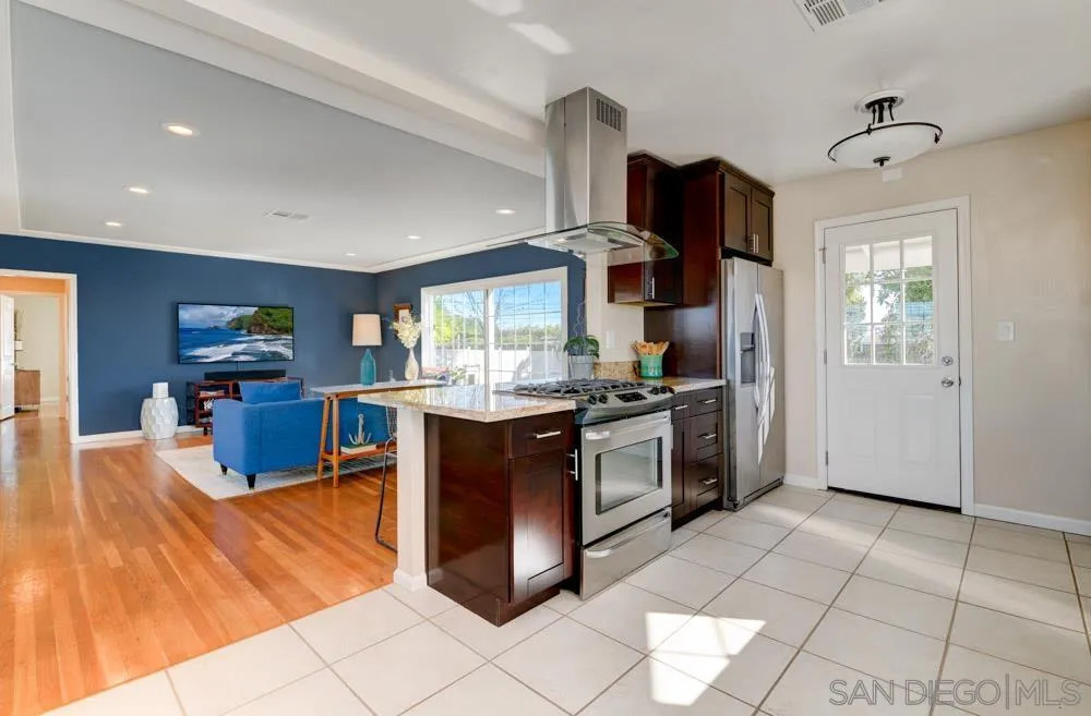 6244 Lorca Drive San Diego, CA 92115 - Photo 9 of 25 a kitchen with stainless steel appliances granite countertop a stove and a refrigerator