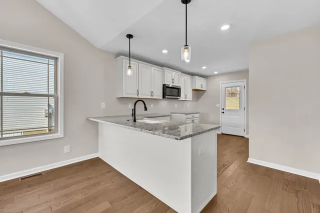 a view of kitchen with cabinets and wooden floor