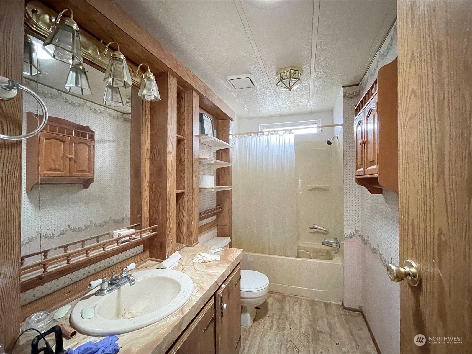 493 Spencer Road Sequim, WA 98382 - Photo 21 of 40 a bathroom with a sink toilet a mirror and shower