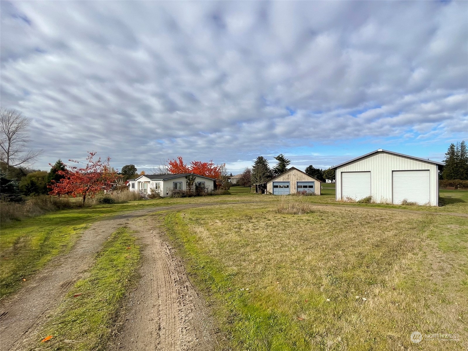 493 Spencer Road Sequim, WA 98382 - Photo 6 of 40 a front view of a house with a garden and yard