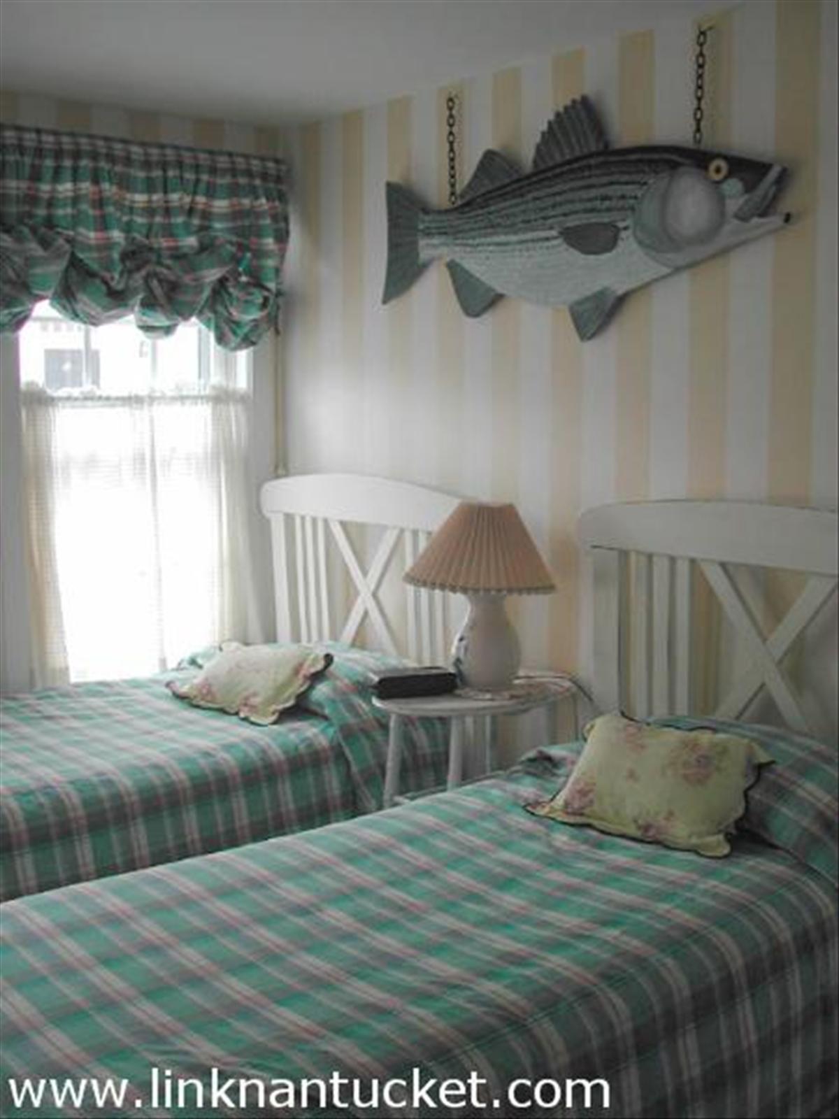 25 Autopscot Circle Nantucket, MA 02554 - Photo 6 of 6 a bed sitting in a bedroom next to a window