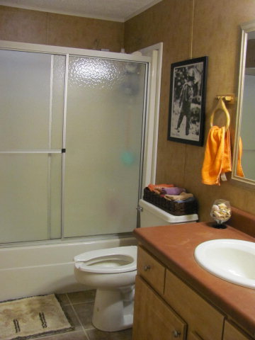 100 Cork Road, Unit 1 2 Forsyth, GA 31029 - Photo 5 of 24 a bathroom with a granite countertop toilet sink and mirror