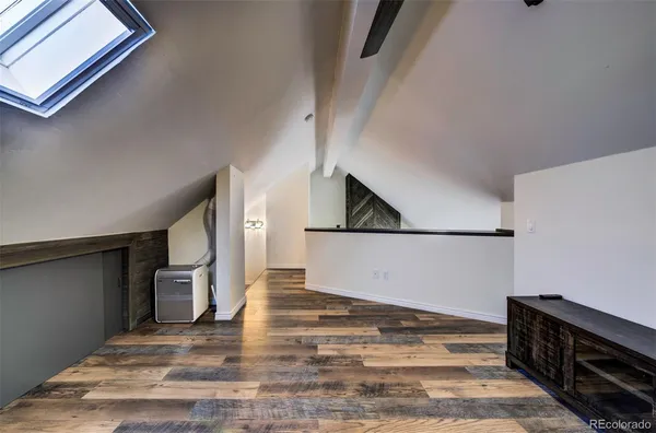 a view of a livingroom with wooden floor and staircase