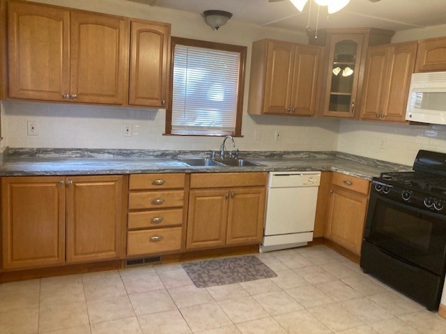 60 Berkeley Street, Unit 1 Somerville, MA 02143 - Photo 1 of 11 a kitchen with a sink stove and cabinets