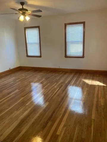 a view of an empty room and wooden floor