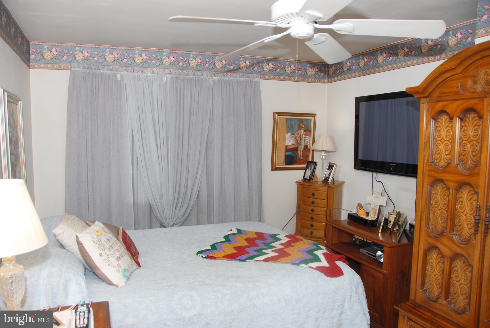 2128 Graythorn Road Baltimore, MD 21220 - Photo 10 of 20 a bedroom with a bed and a chandelier