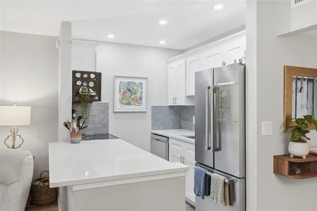 a room with a refrigerator and a sink