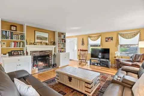 a living room with furniture a flat screen tv and a fireplace