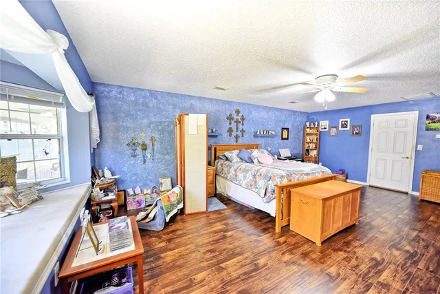 a bed room with furniture and a flat screen tv
