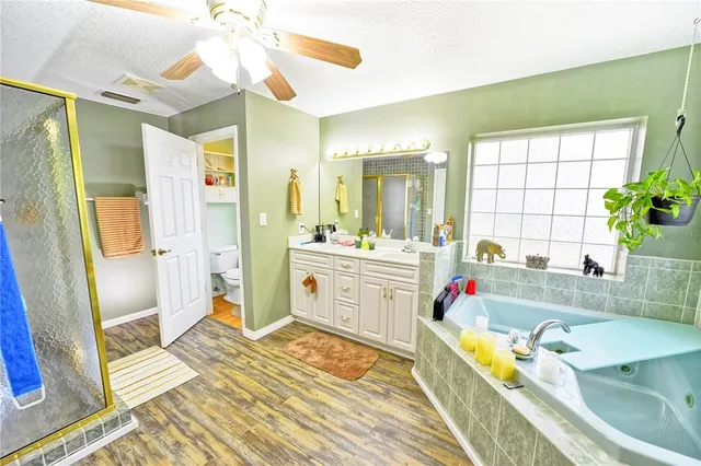 a bathroom with a tub sink and shower