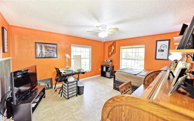 a bedroom with furniture and a flat screen tv