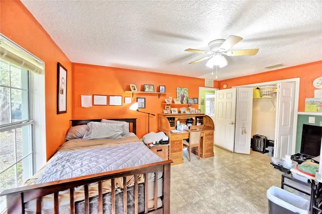 a bedroom with furniture and large window