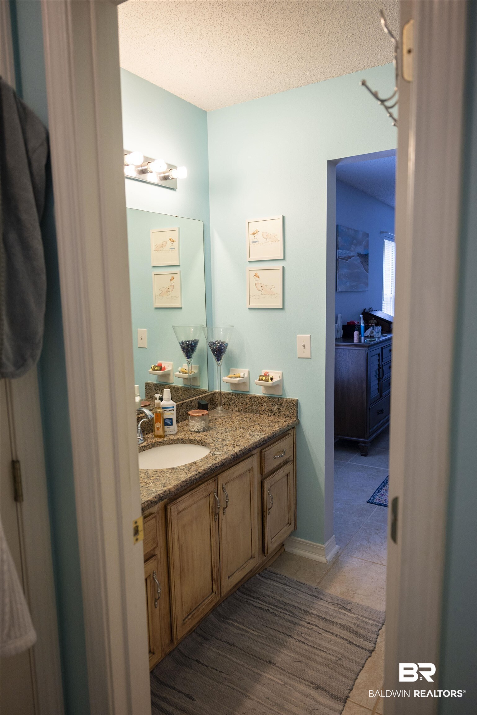 808 Wisteria Lane Foley, AL 36535 - Photo 13 of 19 Bathroom featuring vanity, a textured ceiling, and tile patterned floors