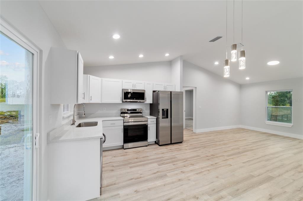 15776 Southwest 27th Lane Ocala, FL 34481 - Photo 20 of 39 a kitchen with stainless steel appliances a refrigerator sink and stove