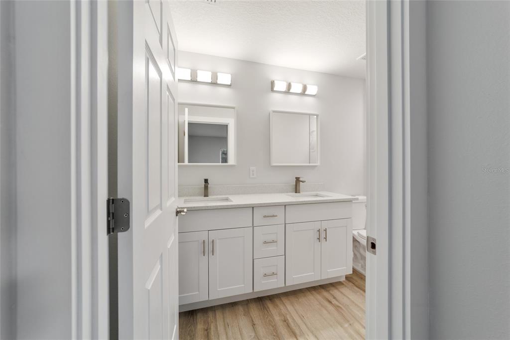 15776 Southwest 27th Lane Ocala, FL 34481 - Photo 26 of 39 a spacious bathroom with a double vanity sink a mirror and shower