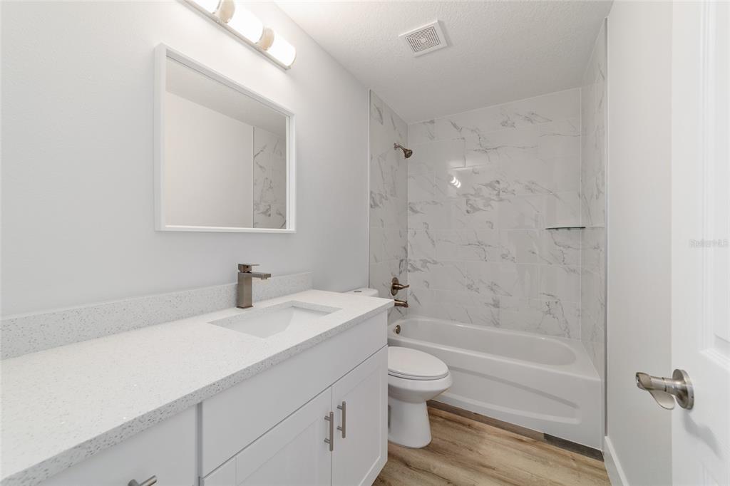 15776 Southwest 27th Lane Ocala, FL 34481 - Photo 34 of 39 a bathroom with a granite countertop sink a toilet and shower