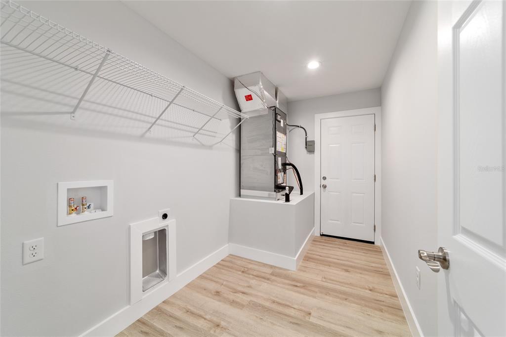15776 Southwest 27th Lane Ocala, FL 34481 - Photo 38 of 39 a view of a storage & utility room with wooden floor