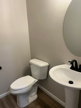 a white toilet sitting next to a bathroom sink