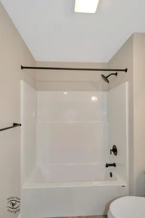 a bathroom with a shower and a toilet