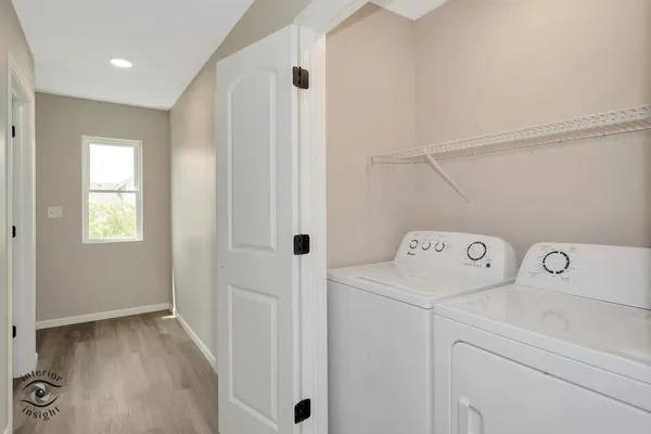a view of storage and utility room with washer and dryer