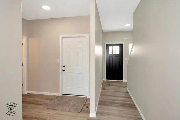 a view of a hallway with wooden floor