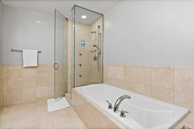 a bathroom with a bathtub and shower
