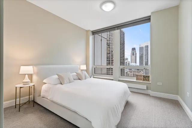 a bedroom with a large bed and a large window