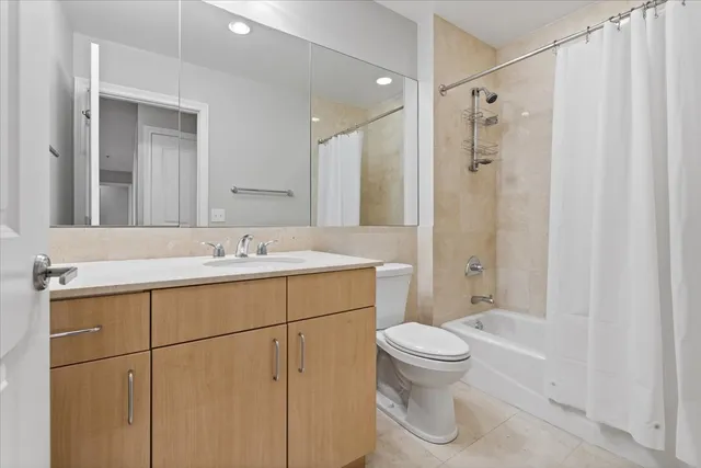 a bathroom with a sink a toilet and a large mirror