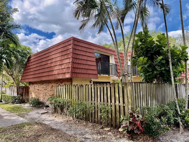 a view of a house with a flower garden