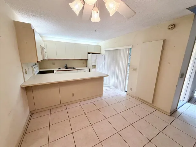 a room with a white cabinets and washer dryer