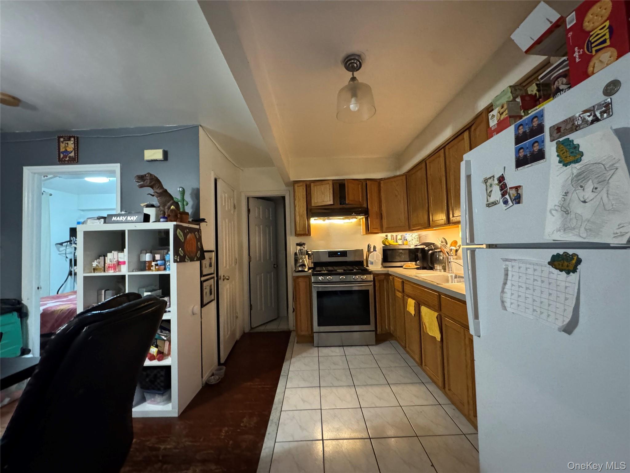 103-25 Alstyne Avenue Queens, NY 11368 - Photo 12 of 22 a kitchen with refrigerator and cabinets