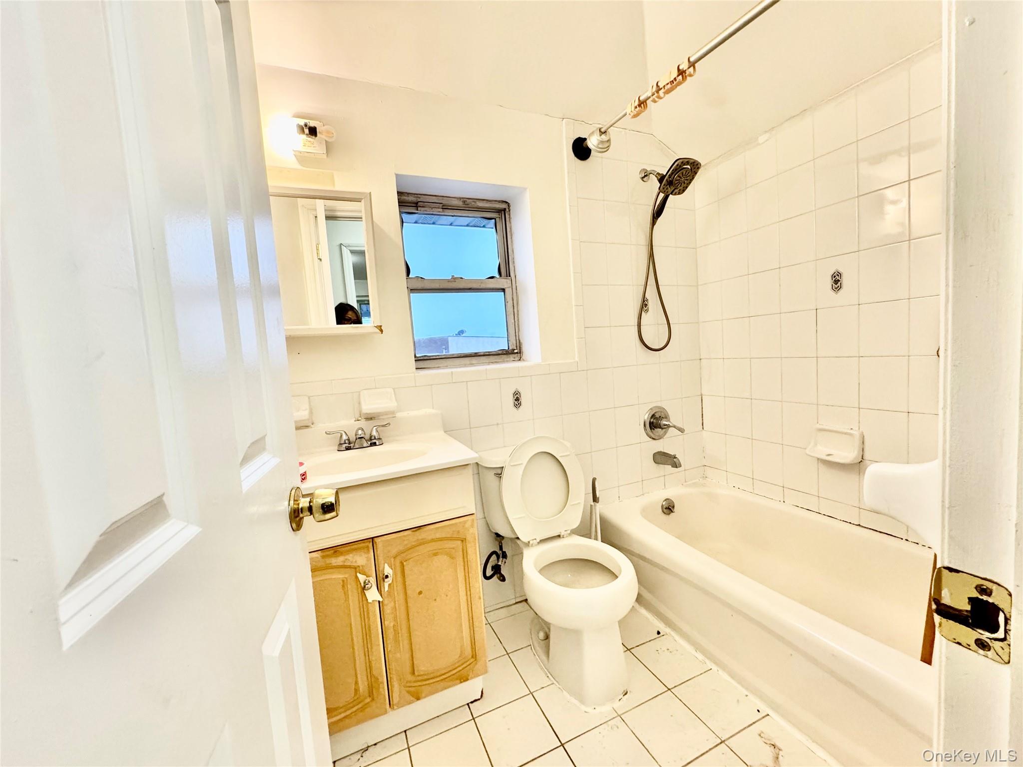 103-25 Alstyne Avenue Queens, NY 11368 - Photo 15 of 22 a bathroom with a granite countertop toilet sink and mirror