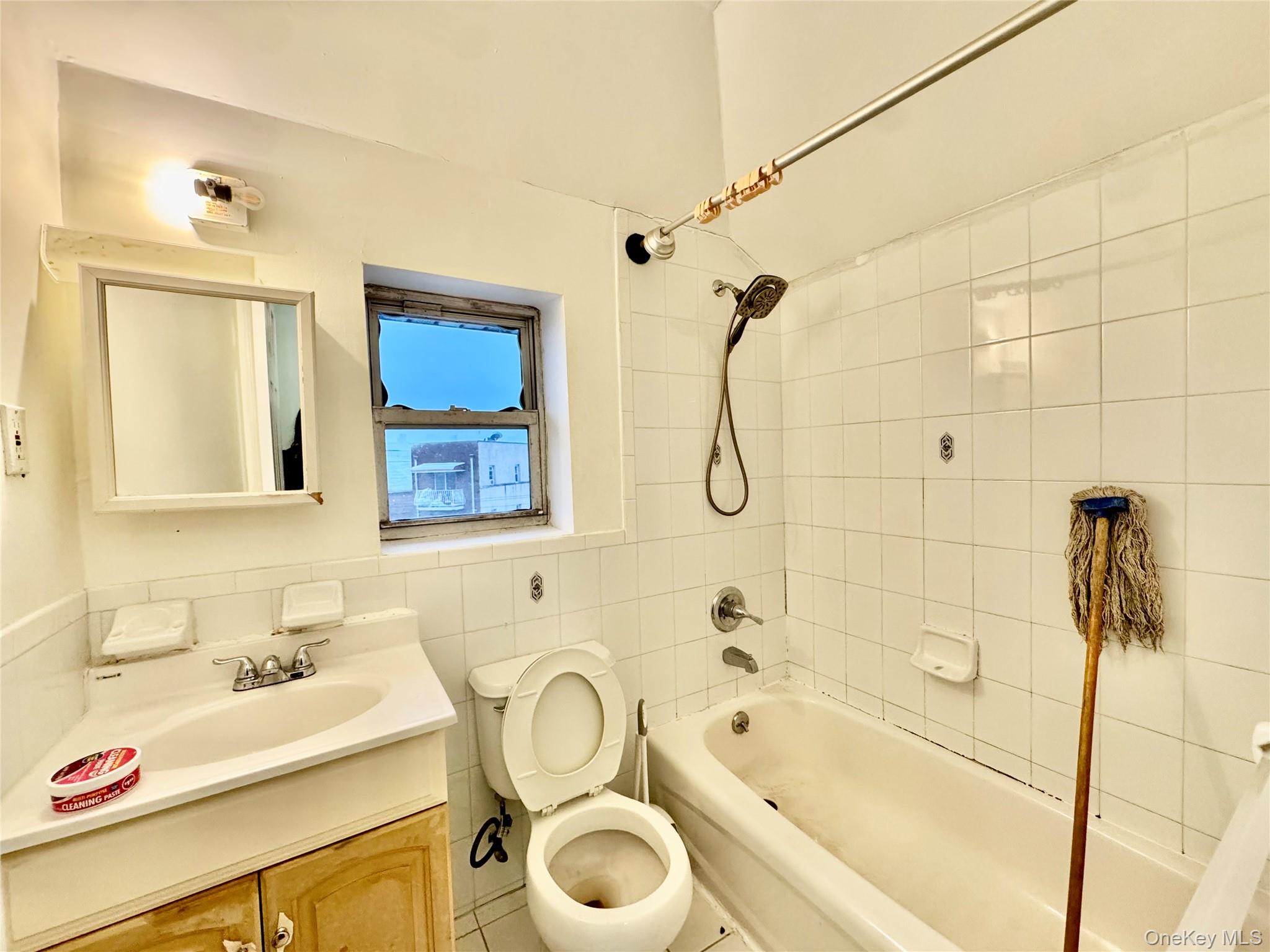 103-25 Alstyne Avenue Queens, NY 11368 - Photo 16 of 22 a bathroom with a sink mirror toilet and bathtub