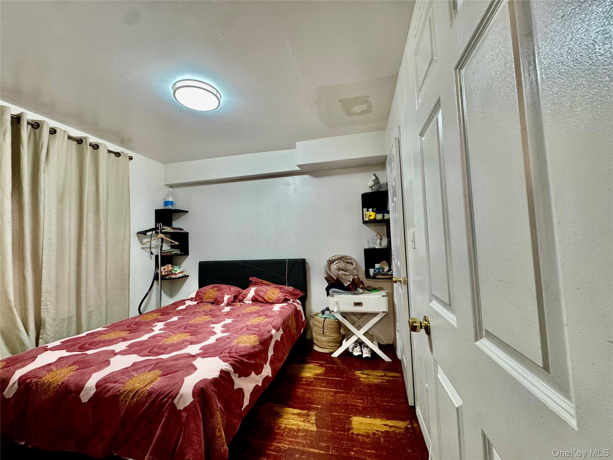 103-25 Alstyne Avenue Queens, NY 11368 - Photo 18 of 22 a bed sitting in a bedroom next to a window