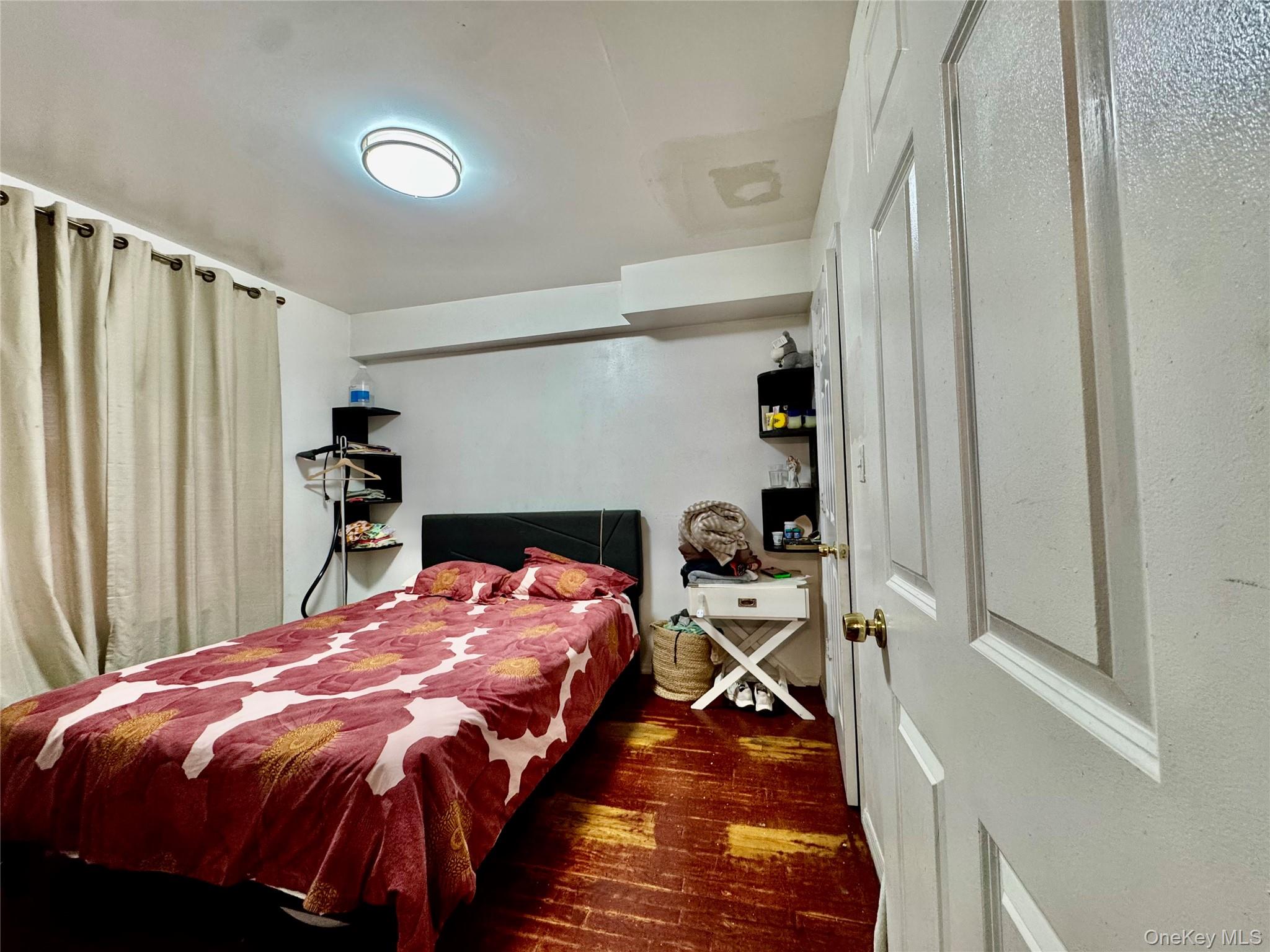 103-25 Alstyne Avenue Queens, NY 11368 - Photo 19 of 22 a bed sitting in a bedroom next to a window