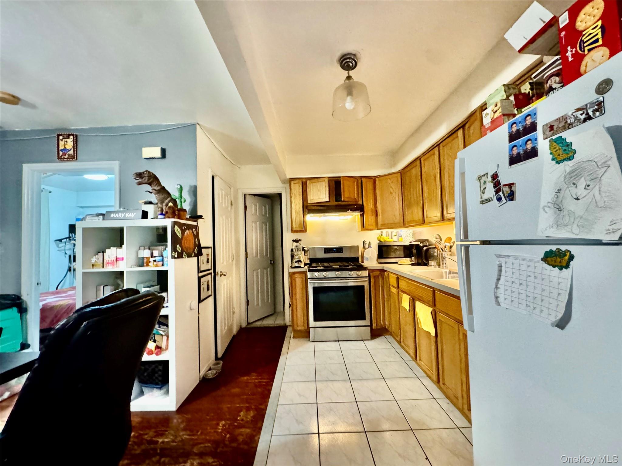 103-25 Alstyne Avenue Queens, NY 11368 - Photo 22 of 22 a kitchen with refrigerator and cabinets